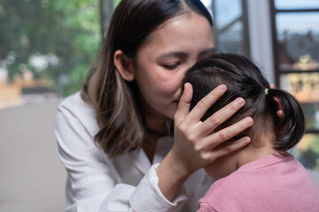 A tender moment between a mother and child, showcasing affection and emotional connection in a...