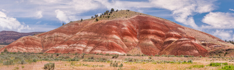 Colorful red painted hills caused by erosion, climate changes and volcanic activity in Eastern...
