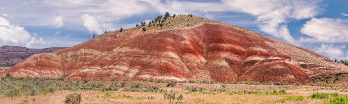 Colorful red painted hills caused by erosion, climate changes and volcanic activity in Eastern Oregon.