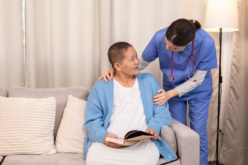 Obraz premium Nurse standing beside senior woman with book, both sharing a caring moment and discussing treatment at home, showing professional and emotional care, healthcare, caregiver, hospitality.