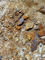 Rust Fragments Scattered on Concrete Surface