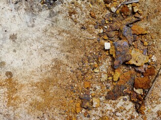 Rust Fragments Scattered on Concrete Surface