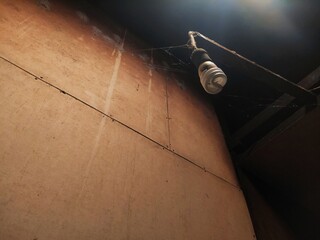 Old Bulb and Cobwebs Under Ceiling Shadow