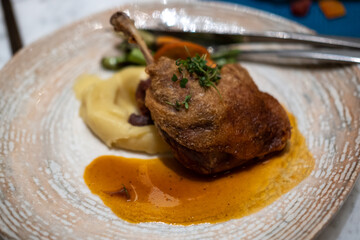 Tender duck confit with crispy skin, served with mashed potato