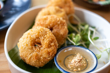 Thai style deep fried shrimp cake served on plate with sauce