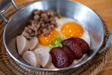 Thai style Skillet egg. A pan fried egg with toppings including Thai pork sausage, ground pork and...