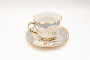 Elegant vintage porcelain teacup and saucer with gold floral design ideal for tableware or antique collection display classic style
