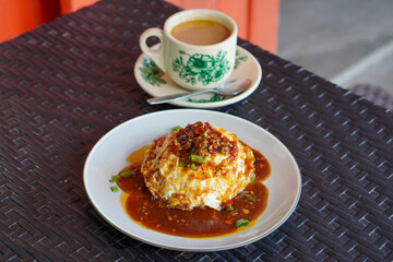 Pontianak Egg Rice, Indonesia, captured on June 29, 2025. A popular street food dish featuring steamed rice topped with fluffy fried egg, savory soy-based sauce, and crispy shallots.