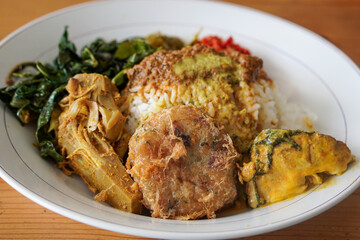 Nasi Padang with Rendang Sauce, Indonesia, captured on June 29, 2025. Traditional Minang rice dish served with rich and spicy rendang sauce, accompanied by vegetables and sambal.
