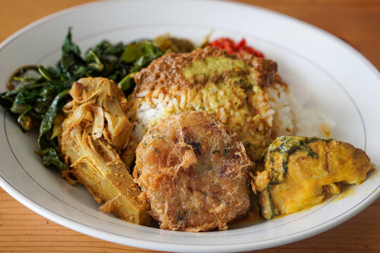 Nasi Padang with Rendang Sauce, Indonesia, captured on June 29, 2025. Traditional Minang rice dish served with rich and spicy rendang sauce, accompanied by vegetables and sambal.