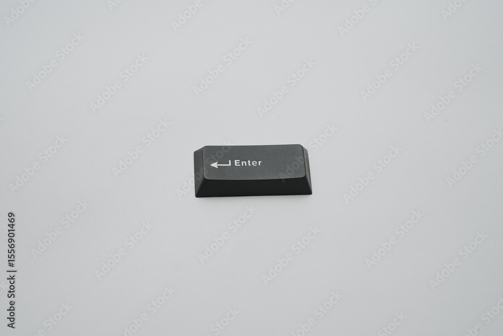 Poster minimalist photographic depiction of an isolated black enter keycap ideal for tech interfaces presen