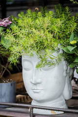 stone vase in the shape of a face