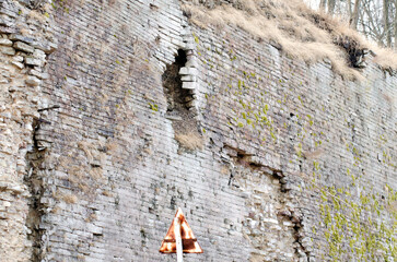 Damaged stone wall with erosion