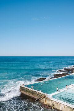 Tourists enjoying bondi icebergs club pool in sydney, australia