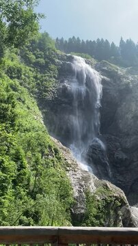 Waterfall flowing in the Austrian Alps in summer day