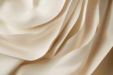 Obraz premium A white fabric with a pattern that looks like a wave. The fabric is folded and has a smooth texture.
