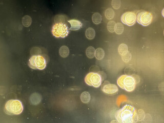 A blurry image of many small circles, some of which are yellow