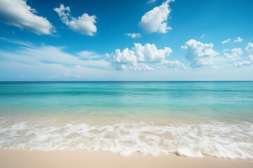 Obraz premium A tranquil beach with clear turquoise waters, soft sand, and fluffy clouds in the bright blue sky, evoking a peaceful and idyllic tropical paradise