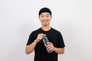 Cheerful asian man black shirt hold water bottle happy smile  isolated
