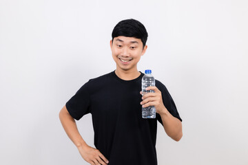 Positive asian man black shirt gesture open water bottle with happy smile look down at space isolated