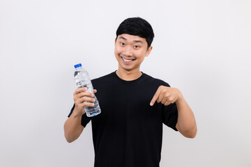 Positive asian man black shirt gesture open water bottle with happy smile point finger down isolated