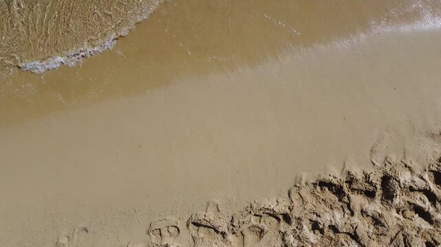 Scenic Beach Footage. Enjoy the Calm Waves and Soft Sand. Ideal for Relaxation, Travel, and Environmental Projects. Experience the Beauty of Nature.