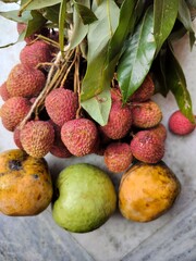 Raw Litchi, also known as lychee or lichee with others fruits such as mango, guava etc. Display close view. Fresh edible fruits in summer.