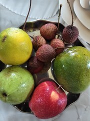 Raw Litchi, also known as lychee or lichee with others fruits such as mango, guava, apple, lemon etc. Display close view. Fresh edible fruits in summer.