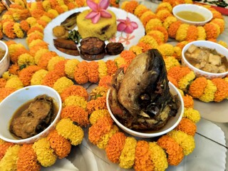 Hindu blessed food for God and rituals as per culture, offerings to the deity, or sacred food for grace or blessing in religious offering in Hinduism. Decorated with marigold flowers and garlands.