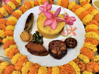 Hindu blessed food for God and rituals as per culture, offerings to the deity, or sacred food for grace or blessing in religious offering in Hinduism. Decorated with marigold flowers and garlands.