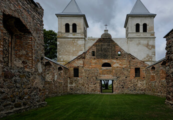Grand, aged church amidst green fields.