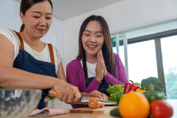 Cooking Together. Two women enjoying a fun cooking session with fresh ingredients.