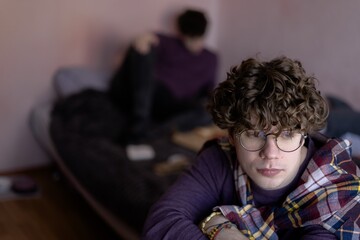 Contemplative moment in a cozy room with friends reflecting on life and connection during a quiet...