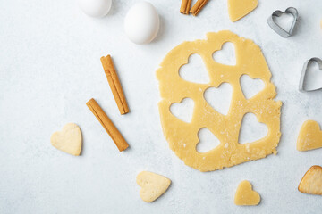 Heart cookie preparation and cinnamon sticks for love baking or romantic valentines day concept
