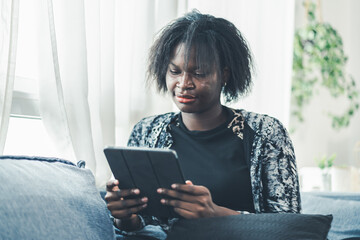 Business, working, technology, Black woman freelancer smiling while using laptop at home, relaxed...