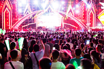Cheering crowd in front of bright stage lights