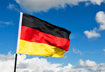 German flag waving against blue sky