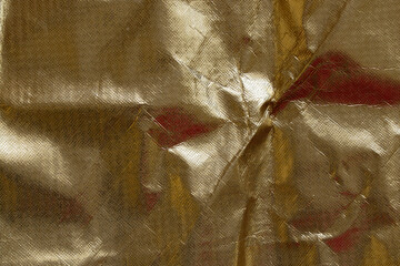 Gold glitter background with oilcloth texture, abstract material with gloss and folds for...