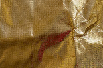 Gold glitter background with oilcloth texture, abstract material with gloss and folds for...
