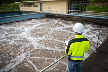 A wastewater treatment engineer is inspecting the operation of a water treatment plant