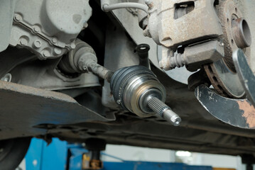 Car service. Repair of the car's front suspension.Replacement of the CV joint. A close-up of the...