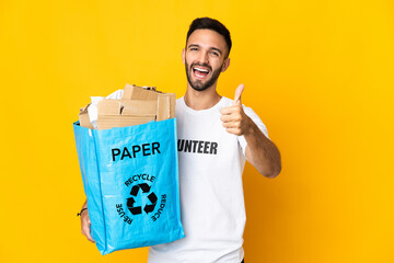 Young caucasian man holding a recycling bag full of paper to recycle isolated on white background...
