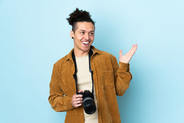 Photographer man over isolated blue background with surprise facial expression
