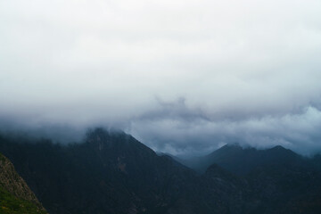 Misty haze envelops the mountain peaks