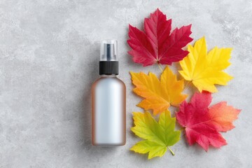 Silver Spray Bottle with Autumn Leaves on Glittery Background