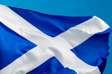 Scottish flag waving on blue background