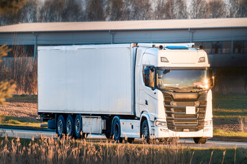 White commercial truck traveling on transit route