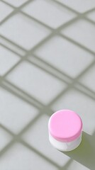 Pink and White Cosmetic Jar on Grid Pattern Shadow
