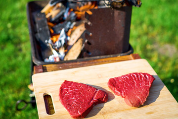 Outdoor cooking of Angus steak on flame