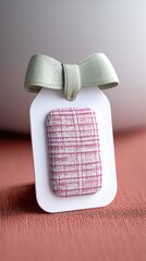 Pink and White Fabric Gift Tag with Cream Bow on Linen Texture